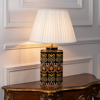 White shade table lamp featuring black and gold geometric ceramic base designed for luxury bedside and living room decor.