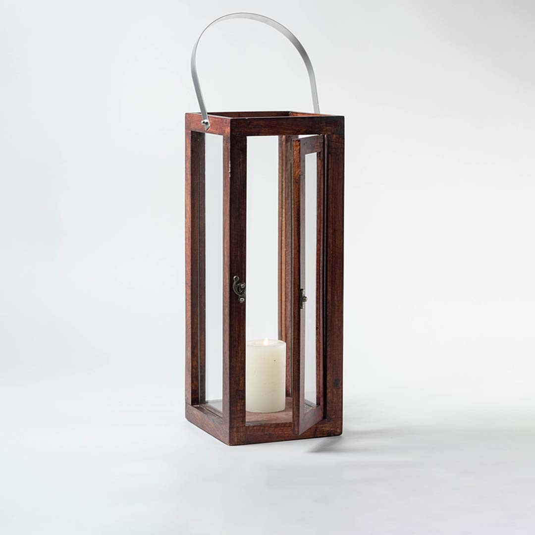 Handcrafted wooden glass lantern with metal handle shown on white background ideal for candle decor and styling.