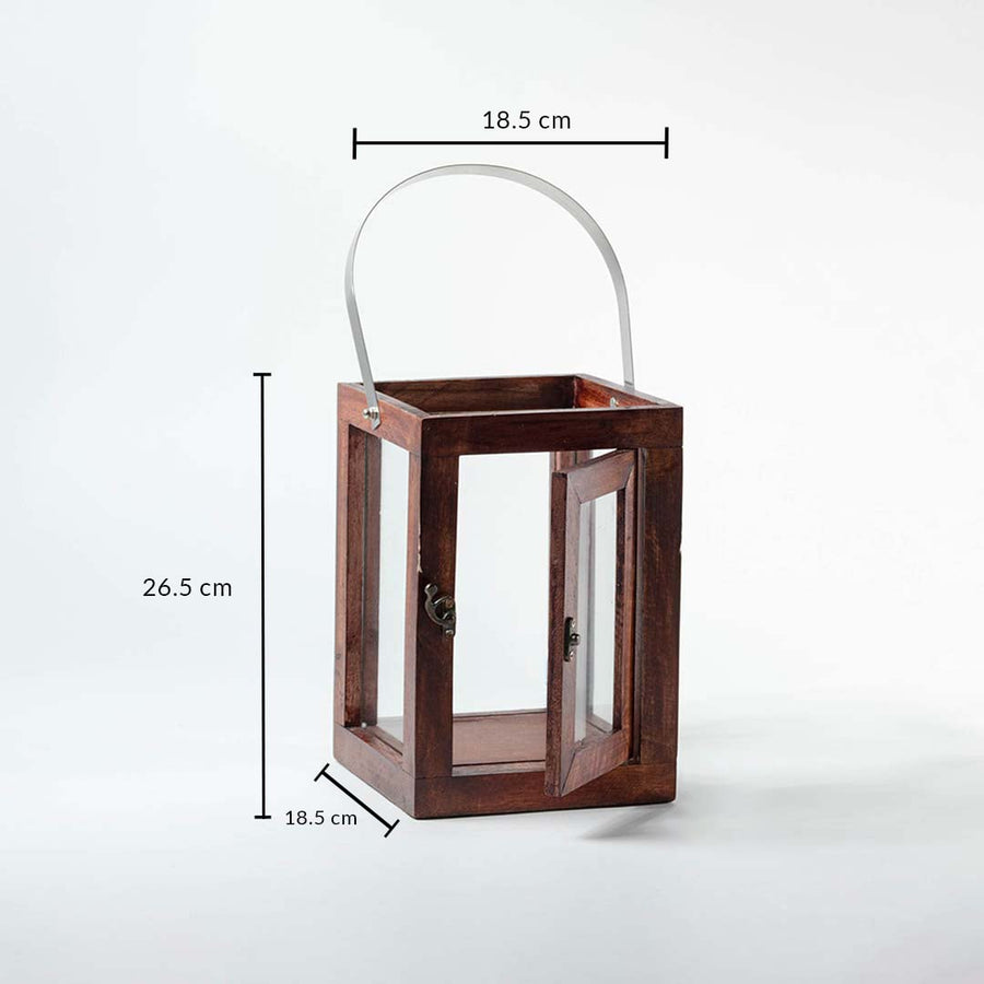 Wooden and glass lantern with silver handle measuring 26.5 cm height and 18.5 cm width shown on white background.