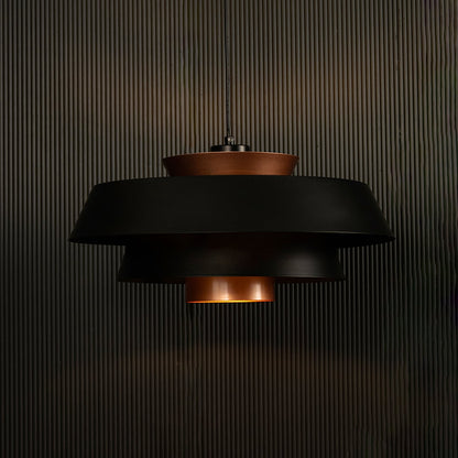 Elegant black and copper pendant light illuminated on dark background showcasing its unique layered industrial design style.