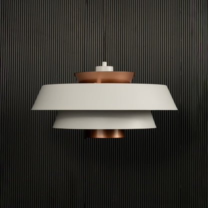 White and copper pendant light displayed on dark background with lights off emphasizing elegant modern metal craftsmanship.