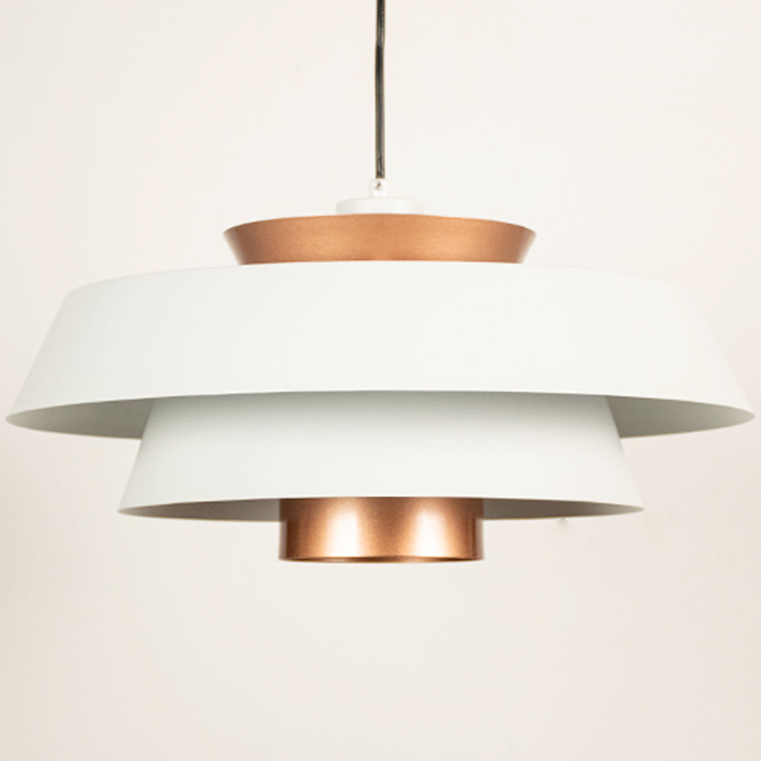 White and copper metal pendant light closeup showcasing layered design and premium finish.