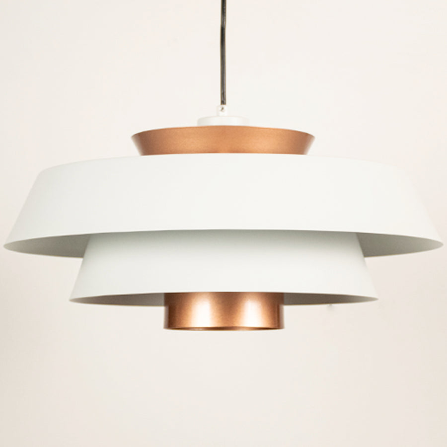 White and copper metal pendant light closeup showcasing layered design and premium finish.