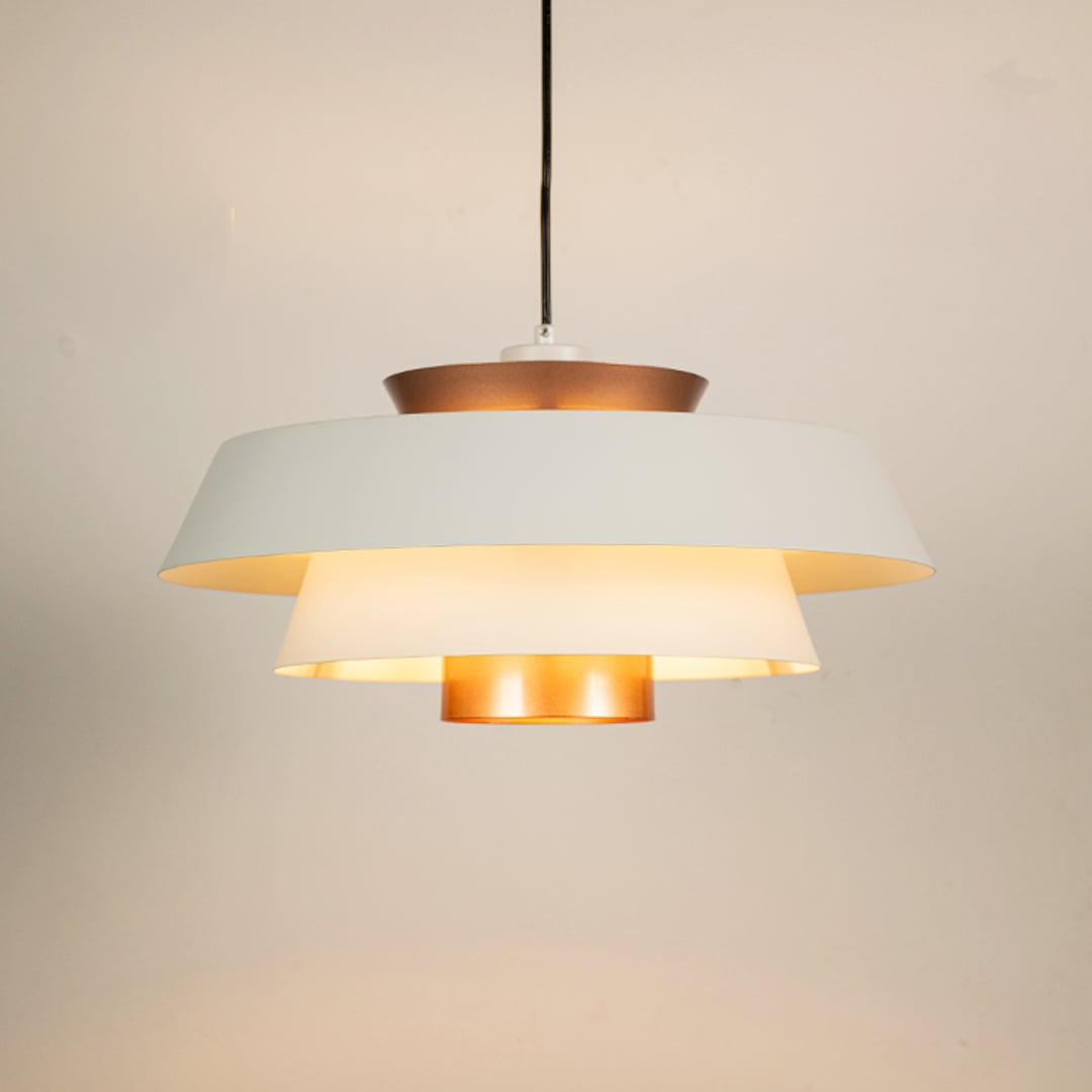 White and copper metal pendant light glowing warmly on white background creating stylish ambience for home office cafe and more spaces.