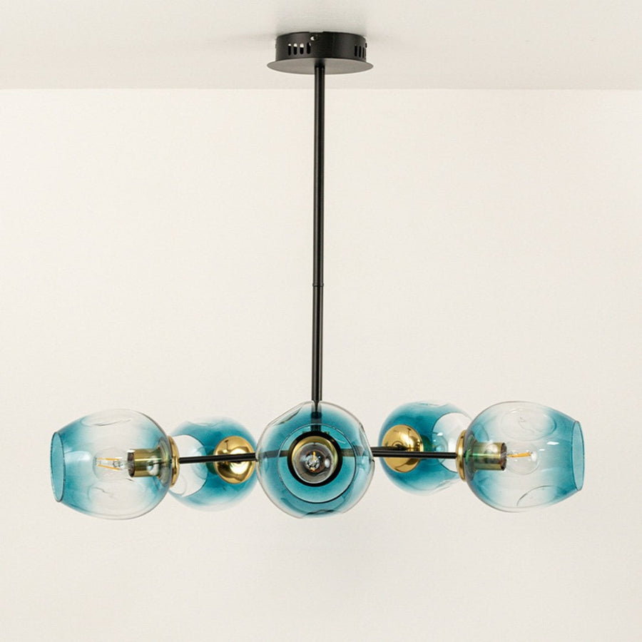 Blue glass chandelier displayed on white background with light off showing clear structure gold detailing black rod and refined glass finish.