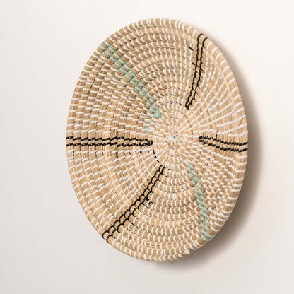 Side view of a woven rattan wall basket showing its depth structure and smooth handcrafted finish.