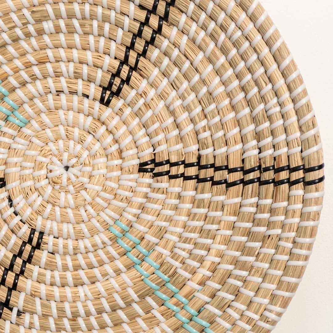 Detailed close-up of a woven wall basket showing intricate rattan weaving and subtle turquoise accent lines.