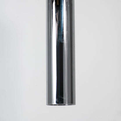 Chrome metal pendant light with reflective polished finish and sleek cylindrical form for modern luxury interior decor.