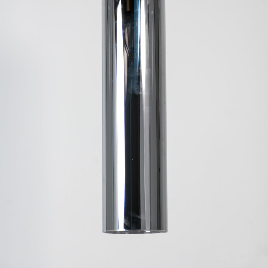 Chrome metal pendant light with reflective polished finish and sleek cylindrical form for modern luxury interior decor.