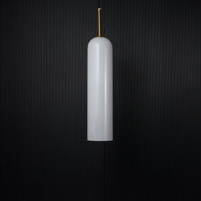 A glossy tall pendant light with the light off showcasing its reflective glass finish and metal accents clearly against a solid black background for a bold presentation.