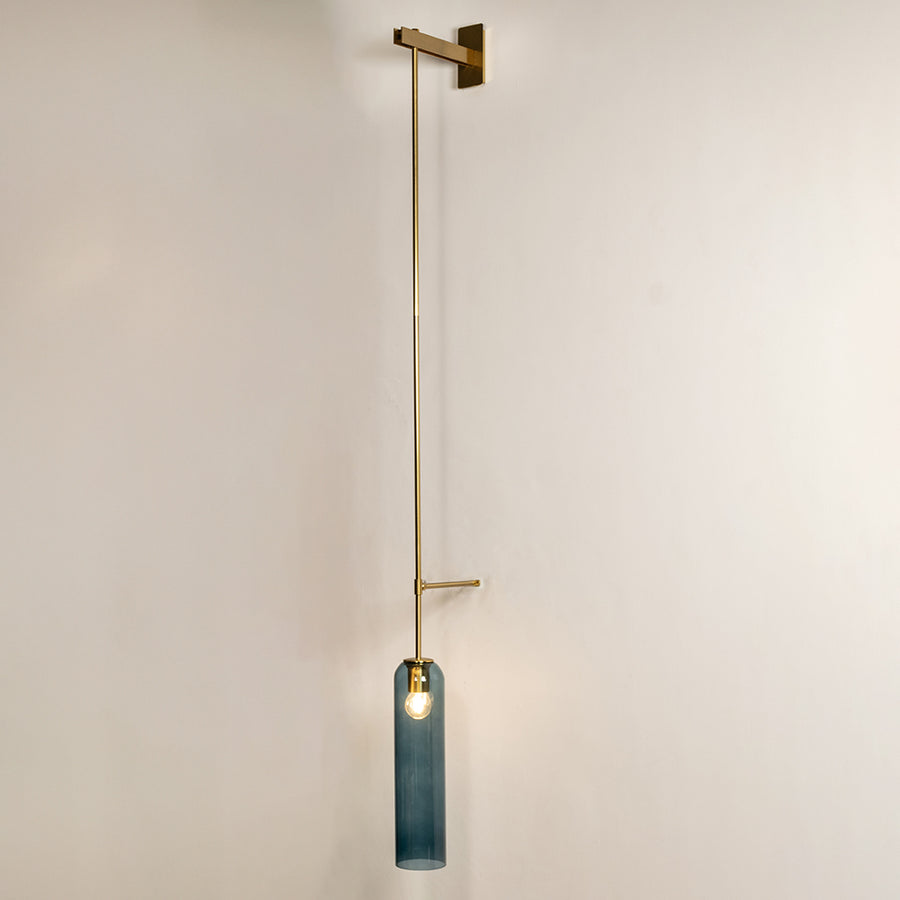 Minimal wall pendant light with gold metal arm and blue glass accent ideal for modern bedroom or living room wall decor.