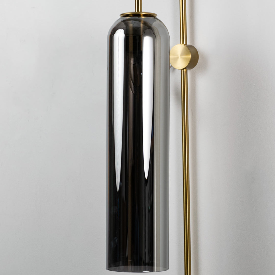 Closeup of black glass and gold metal wall light for modern bedroom and luxury decor styling spaces.

