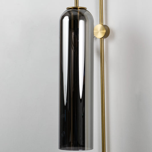 Closeup of black glass and gold metal wall light for modern bedroom and luxury decor styling spaces.

