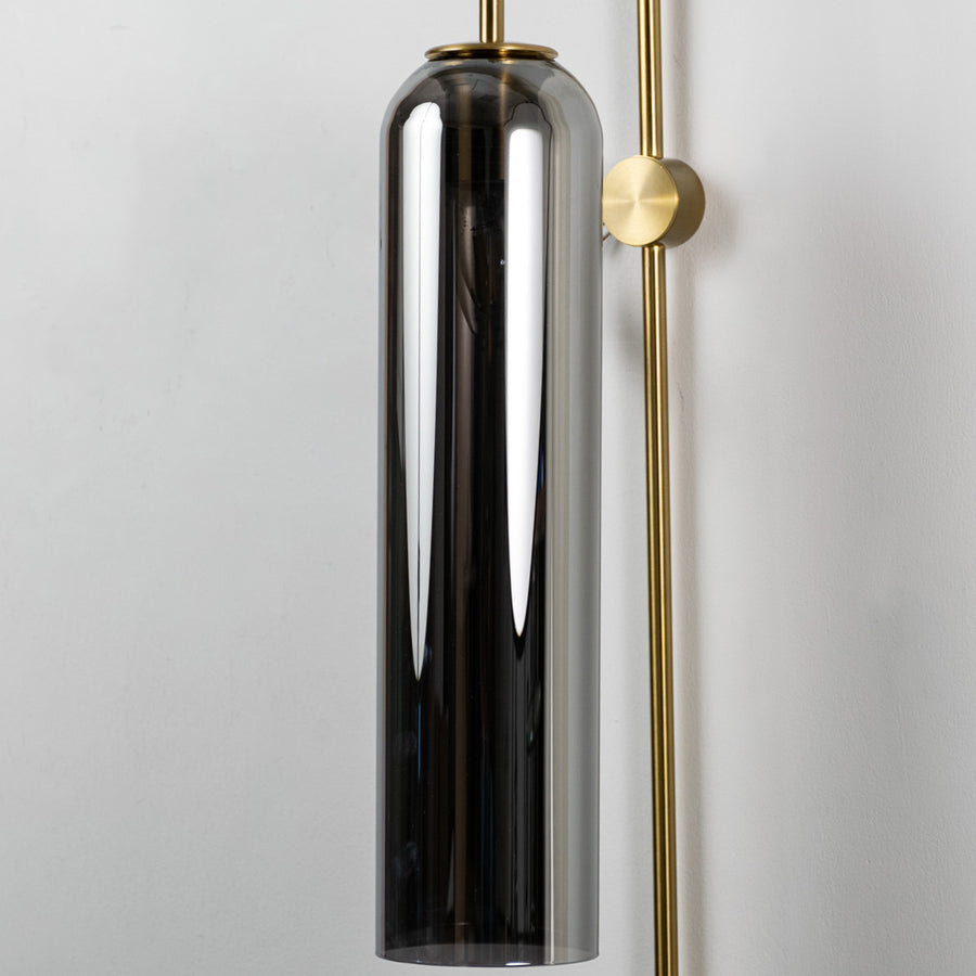 Closeup of black glass and gold metal wall light for modern bedroom and luxury decor styling spaces.

