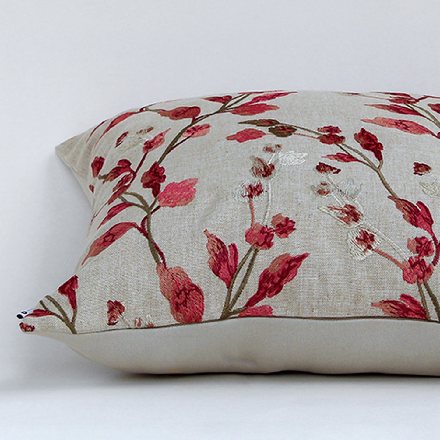 White cotton cushion cover with red botanical leaf print featuring premium cotton fabric texture and elegant stitched finish.