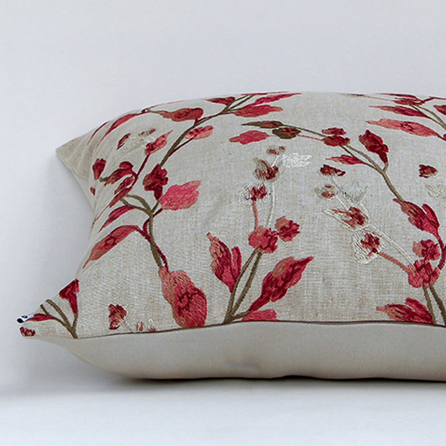 White cotton cushion cover with red botanical leaf print featuring premium cotton fabric texture and elegant stitched finish.