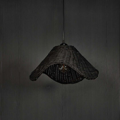 Black rattan pendant light on black background highlighting its sculptural form and fine weave detailing.