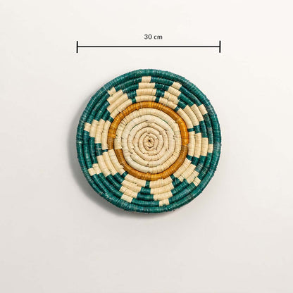 A handwoven teal mustard and natural rattan wall decor plate displayed on a white background clearly showing a diameter of 30 cm for accurate measurement and wall placement.