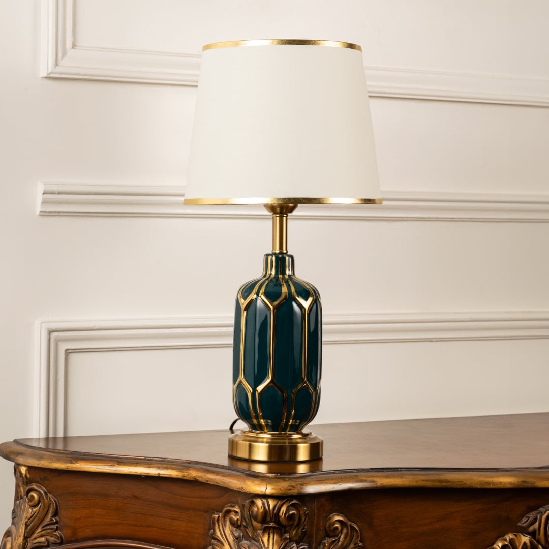 Table lamp with green and gold ceramic base and white shade displayed on a clean white background for clear product view.