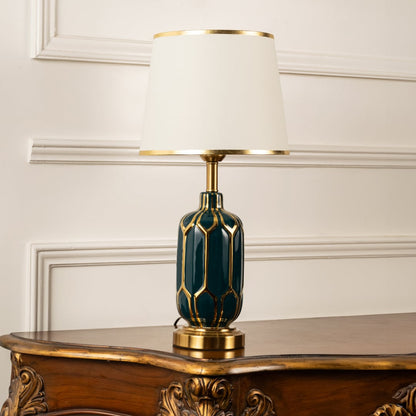 Table lamp with green and gold ceramic base and white shade displayed on a clean white background for clear product view.