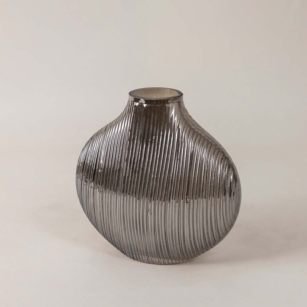 Side angle view of ribbed smoky glass vase showcasing curved profile and glossy surface for a stylish modern tabletop decor piece.