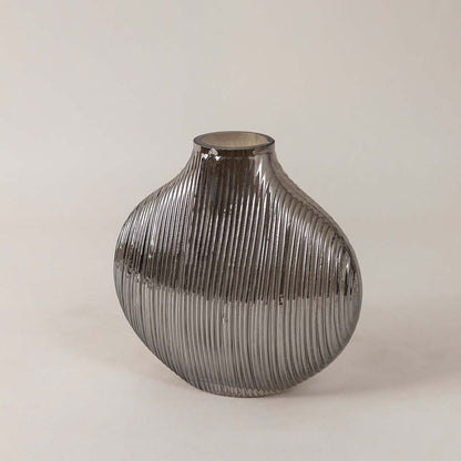 Side angle view of ribbed smoky glass vase showcasing curved profile and glossy surface for a stylish modern tabletop decor piece.