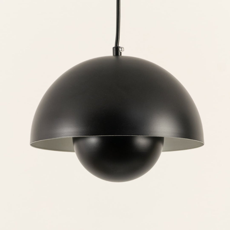 Closeup of modern black dome pendant light highlighting its matte finish and minimalist geometric half-sphere design.