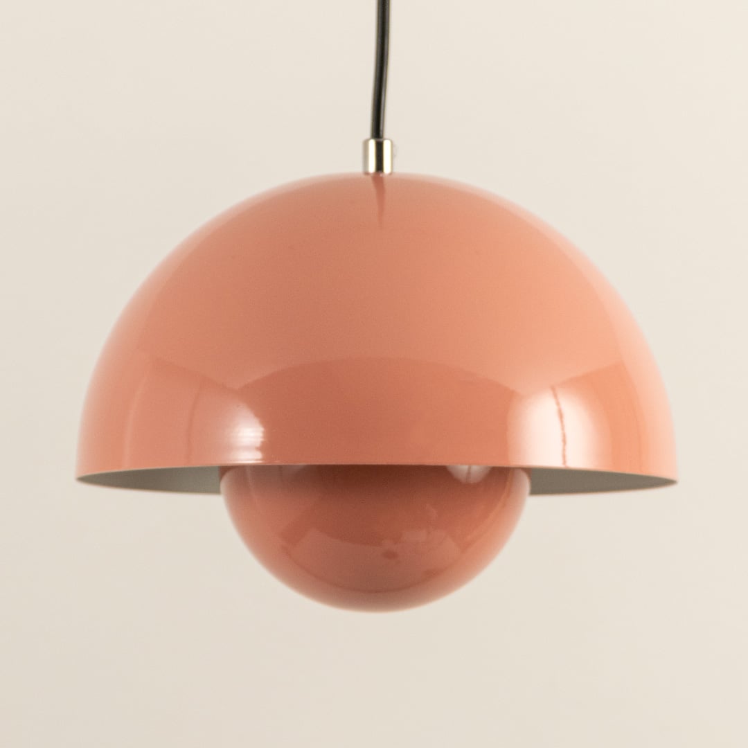 Closeup of terracotta dome pendant light emphasizing its glossy surface and smooth symmetrical form.
