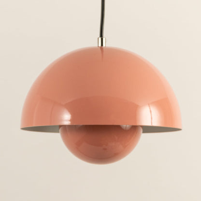Closeup of terracotta dome pendant light emphasizing its glossy surface and smooth symmetrical form.