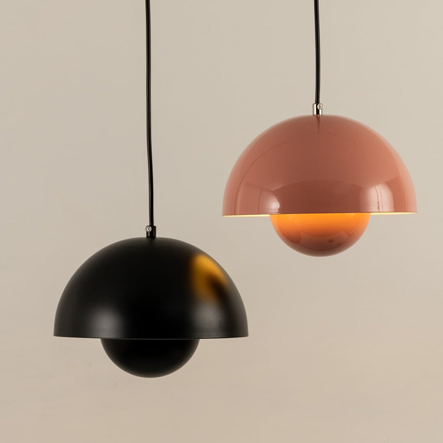 Set of terracotta dome pendant lights softly glowing together creating a warm and inviting atmosphere.