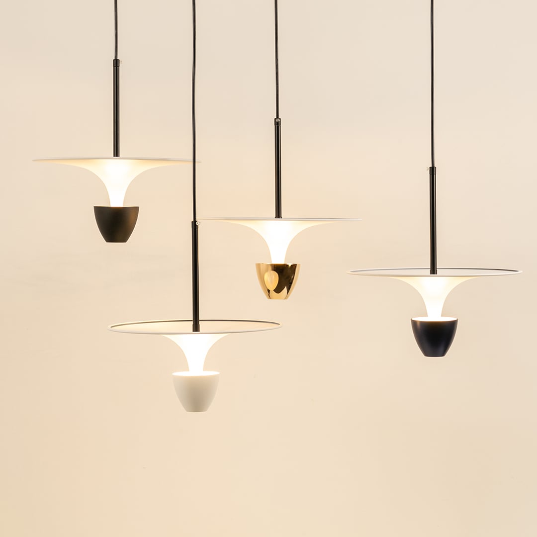White black and gold metal pendant lights illuminated to display contemporary ceiling lighting with minimalist style.