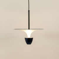 White and black metal pendant light illuminated to showcase sleek modern ceiling lighting with balanced elegance.