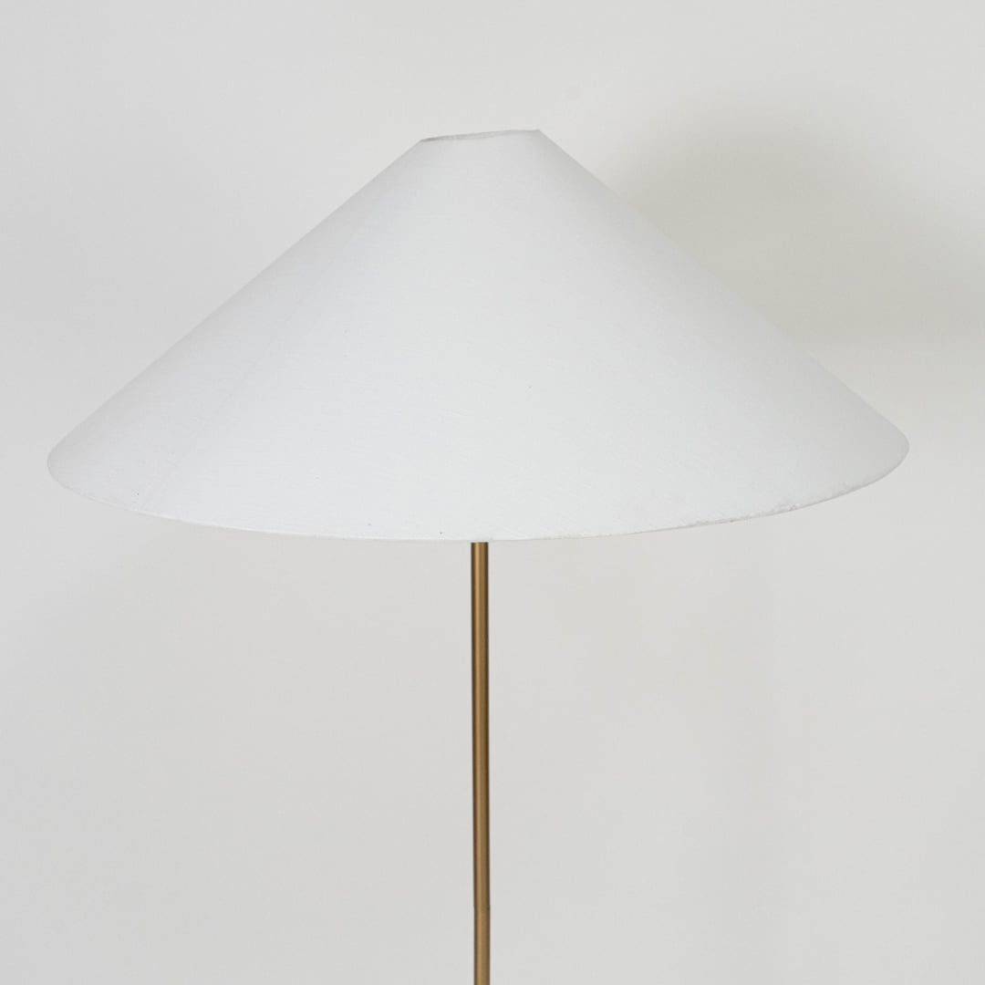 Brushed brass cylindrical lamp base with slim rod support offering sturdy modern design and refined finish.