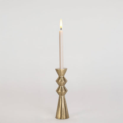 Modern gold metal candle holder with sculpted geometric design displayed on a clean white background for decor.
