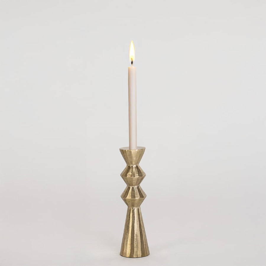 Modern gold metal candle holder with sculpted geometric design displayed on a clean white background for decor.