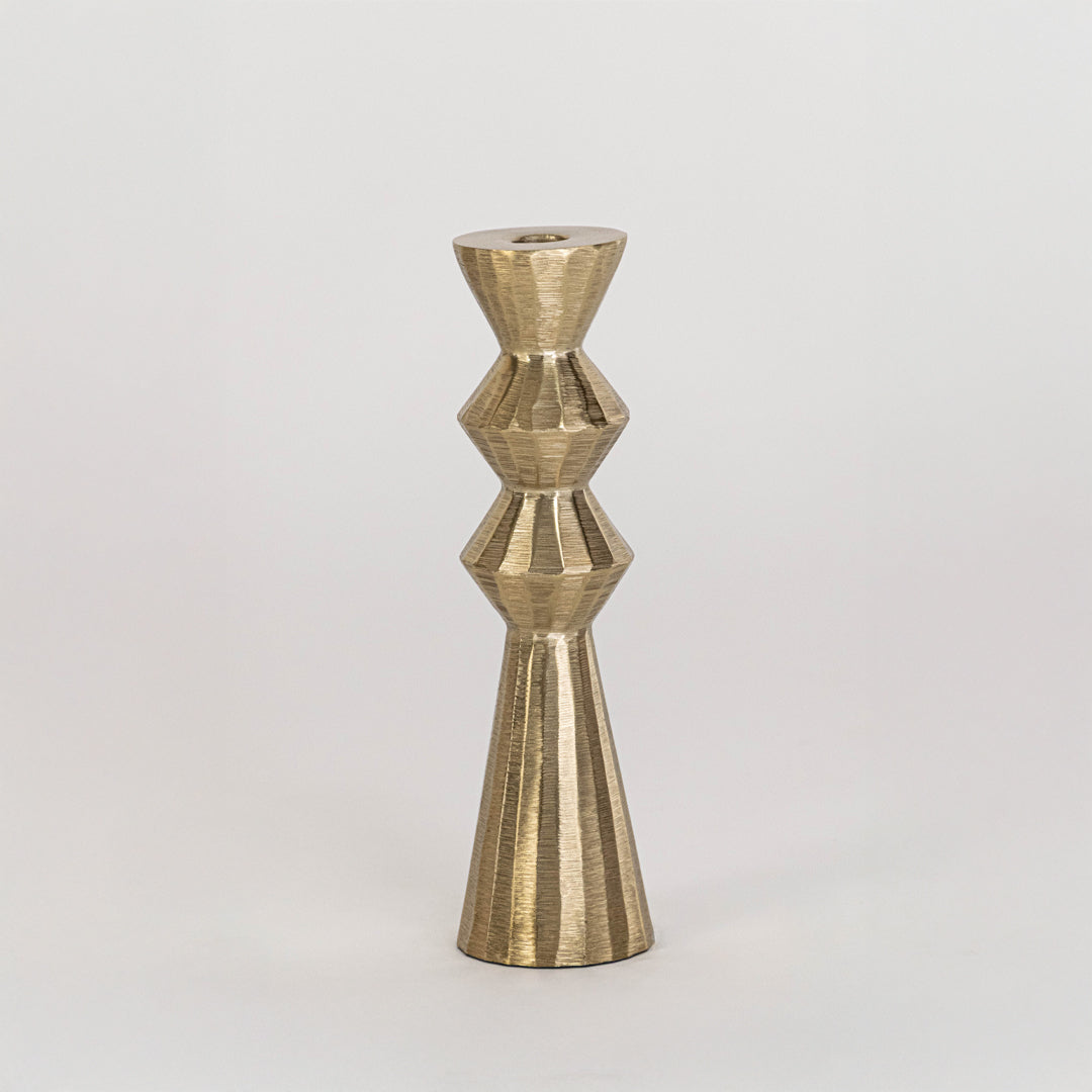Modern metal candle holder in gold finish with geometric shape for table decor or dining styling contemporary home placement white background.