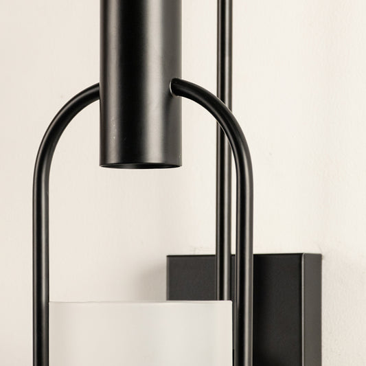 Closeup of black metal and clear glass wall light for modern hallway and luxury decor styling spaces.