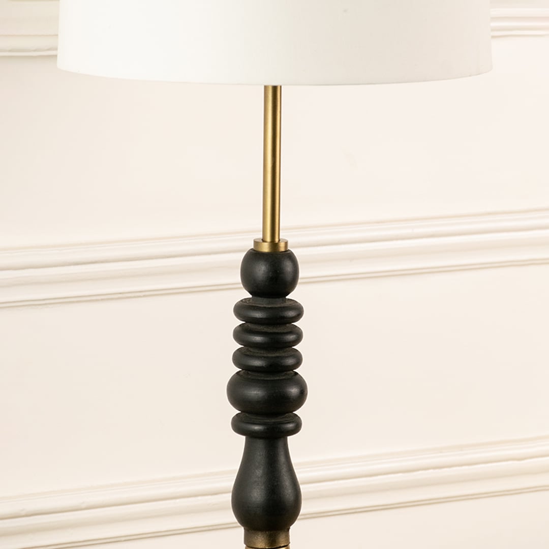 Black turned wood lamp stem with brass rod detail showcasing refined craftsmanship and timeless decorative appeal.