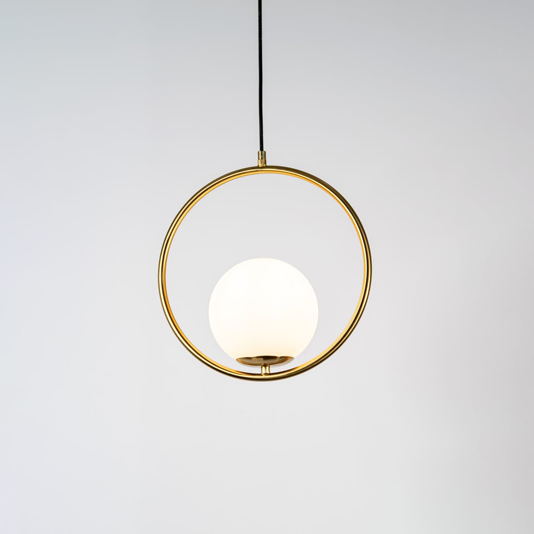 A circular pendant lamp shown with the light on against a clean white background displaying a glowing round diffuser and gold ring frame in a bright minimal style.