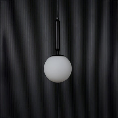 A contemporary pendant light with the bulb off shown on a deep black background highlighting the matte texture and clean geometric shape of the lighting piece.