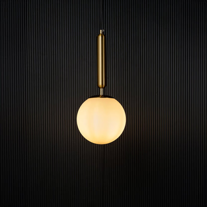 Modern pendant light glowing warmly against a dark background creating a striking contrast that highlights its elegant gold and white finish.