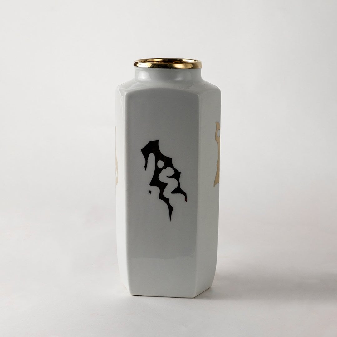 White ceramic jar with black abstract calligraphy design ideal for modern console décor and artistic home styling.