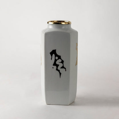 White ceramic jar with black abstract calligraphy design ideal for modern console décor and artistic home styling.