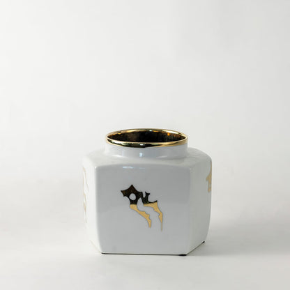 White ceramic decorative storage jar with gold bee artwork for contemporary tabletop styling and modern home decor.