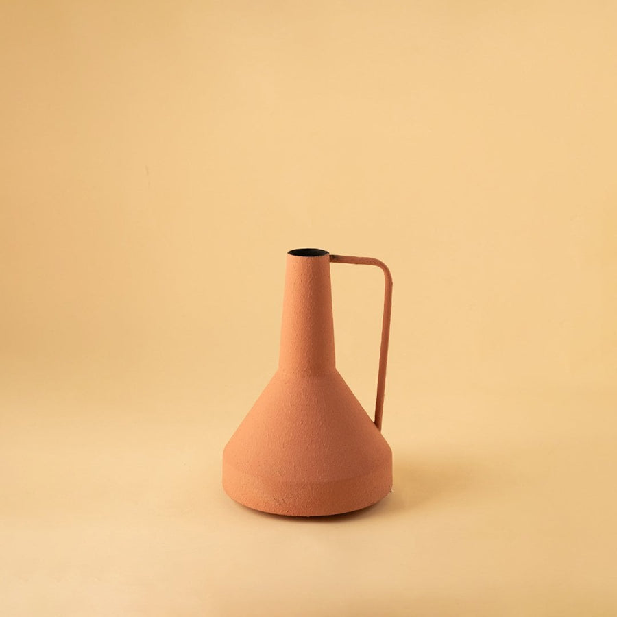 Cream colored ceramic pitcher with minimalist design and angular metal handle perfect for contemporary home decor and flower arrangements.