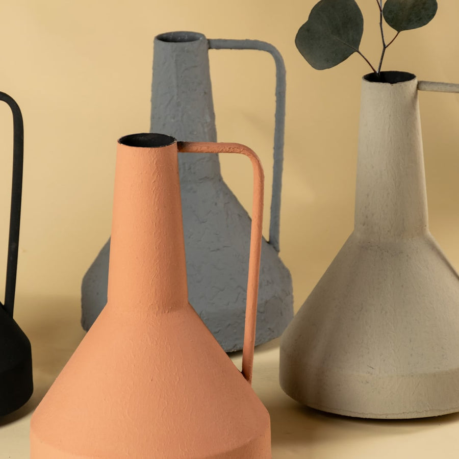 Hand-crafted gray ceramic jug featuring textured surface rough finish and sturdy handle detail showcasing artisan pottery craftsmanship and contemporary design.