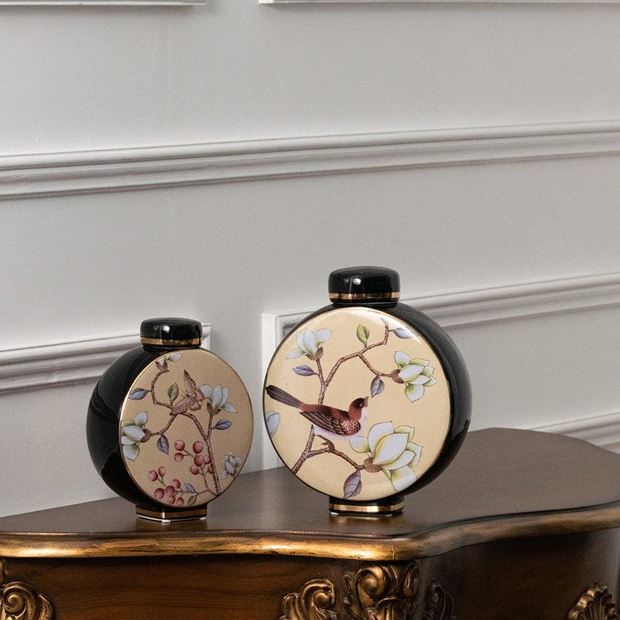 Round ceramic jars with bird artwork arranged on a wooden console table creating a classic decorative décor accent that enhances interior styling beautifully.