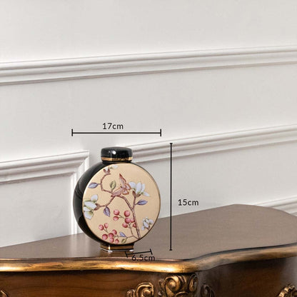 Black round ceramic jar with pastel floral artwork in a front view measuring 13.7 cm width and 15 cm height perfect for elegant décor styling.