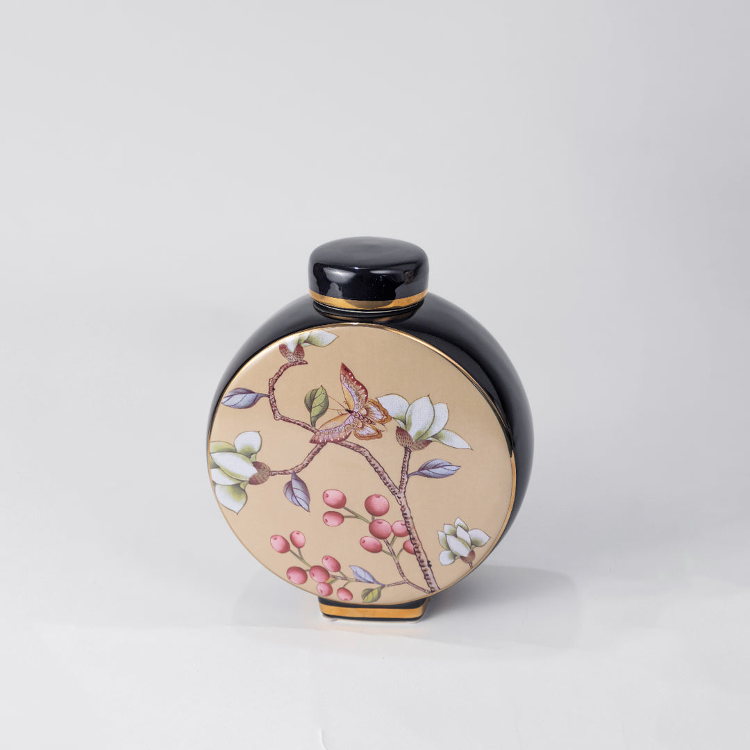 Round ceramic decorative jar with pink blossom artwork for sophisticated shelf styling and contemporary home decor.