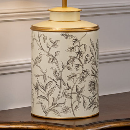 Table lamp closeup highlighting delicate botanical artwork on ceramic base with fine line detailing and smooth glazed finish.
